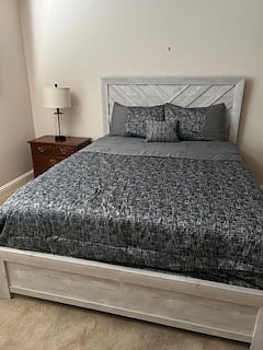 Queen size bed with nightstand, dresser, built in closet, remote controlled ceiling fan with dimmable light, dresser, window with view of front yard and lots of natural light.