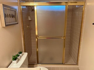Shared bathroom has a double wide shower with window.