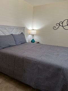Private bedroom with queen size bed, nightstand, chest of drawers, built in closet, remote controlled ceiling fan with dimmable light, locking bedroom door, window with view of backyard and lots of natural light.