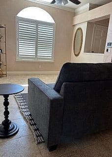 Private sitting room with smart TV, remote controlled ceiling fan with dimmable light and window with view of front yard.
