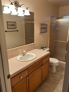 Shared bathroom with double wide shower and window.