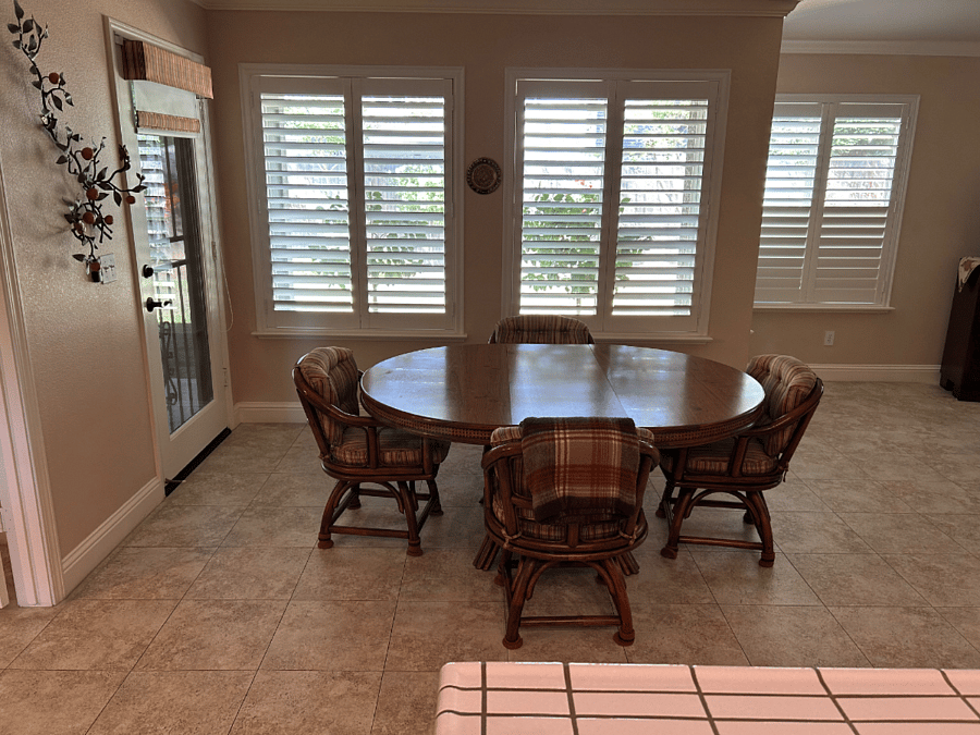 Shared kitchen table with door to patio, view of backyard and lots of natural light.