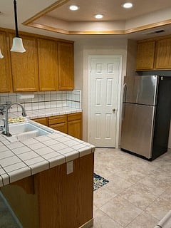 Shared kitchen with full size refrigerator, pantry and view of backyard with lots of natural light.