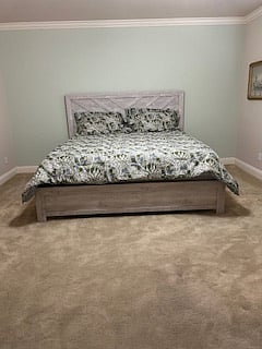 King size bed with locking bedroom door, nightstand, dresser, remote controlled ceiling fan with dimmable light and window with lots of natural light.