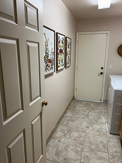Shared laundry room with lots of counter space, sink, window with lots of natural light full size washer, full size dryer and door that opens to garage.