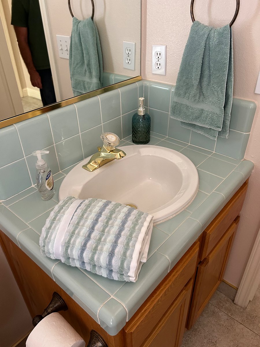Shared half bathroom with window and lots of natural light.