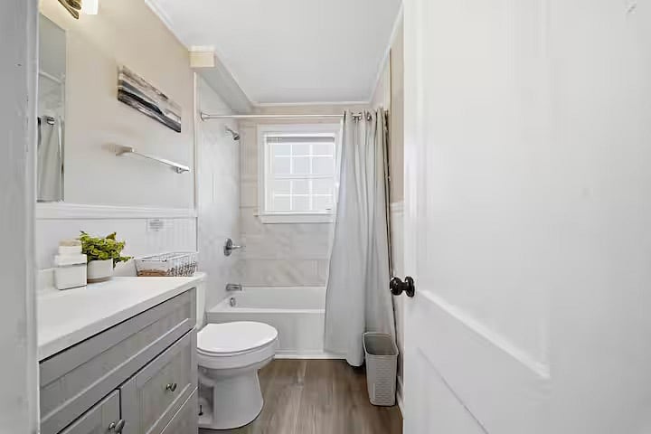 Clean and refreshed bathroom featuring a full tub and shower combo, bright vanity space, and fresh towels. Neutral finishes and natural light create a crisp, comfortable space to start and end your day.