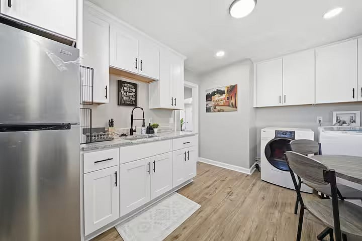 Bright and airy lounge with a large TV and sleek media console for easy streaming. Sunlit windows and soft accents add warmth, making it a comfortable spot to unwind after a day out.