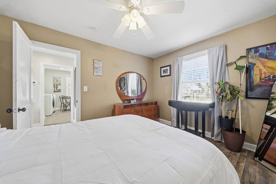 Peaceful bedroom featuring a comfortable bed with crisp linens and plenty of natural light. A small desk by the window offers a quiet spot to work or unwind, while soft tones create a relaxing retreat.