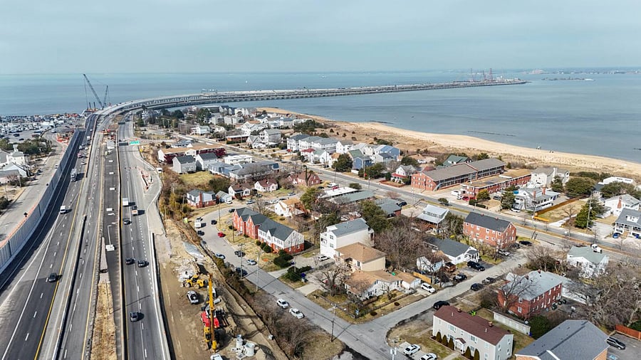 Stunning aerial view of the shoreline and nearby community. Enjoy a prime location close to the beach with quick access to major roads for easy trips around the city.