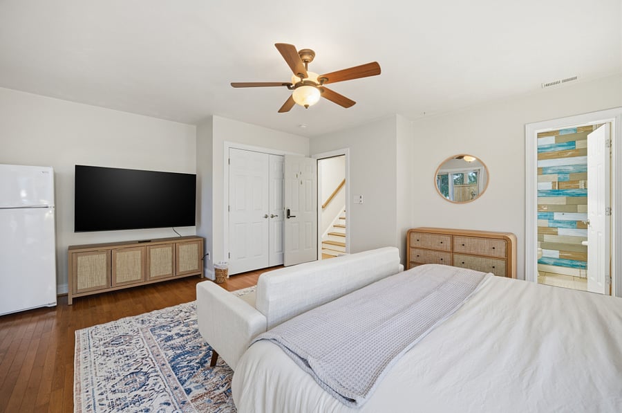 Bedroom with king bed and wall-mounted TV