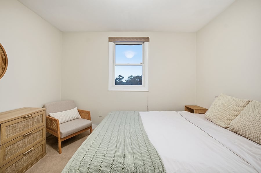 Bedroom with queen bed and natural light