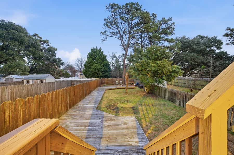 Rear deck overlooking trees and nearby homes