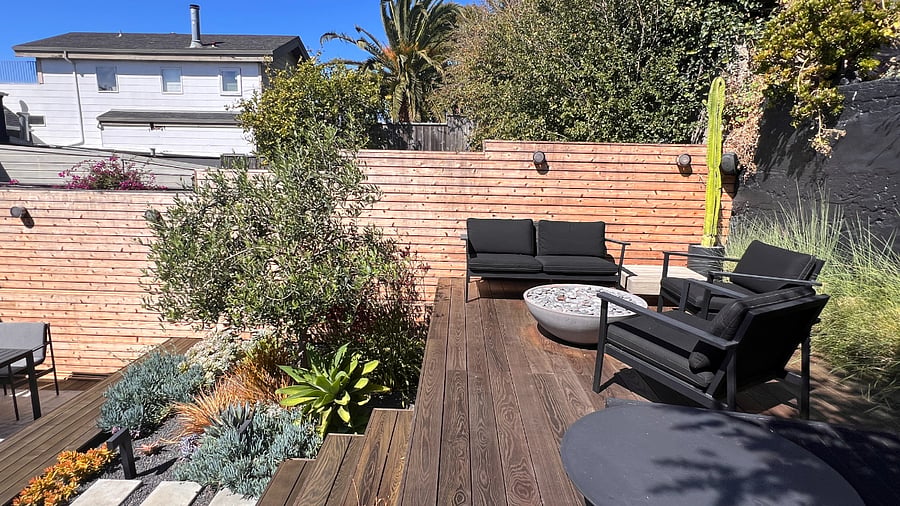 Backyard upper deck with seating/lounging furniture and gas fire pit