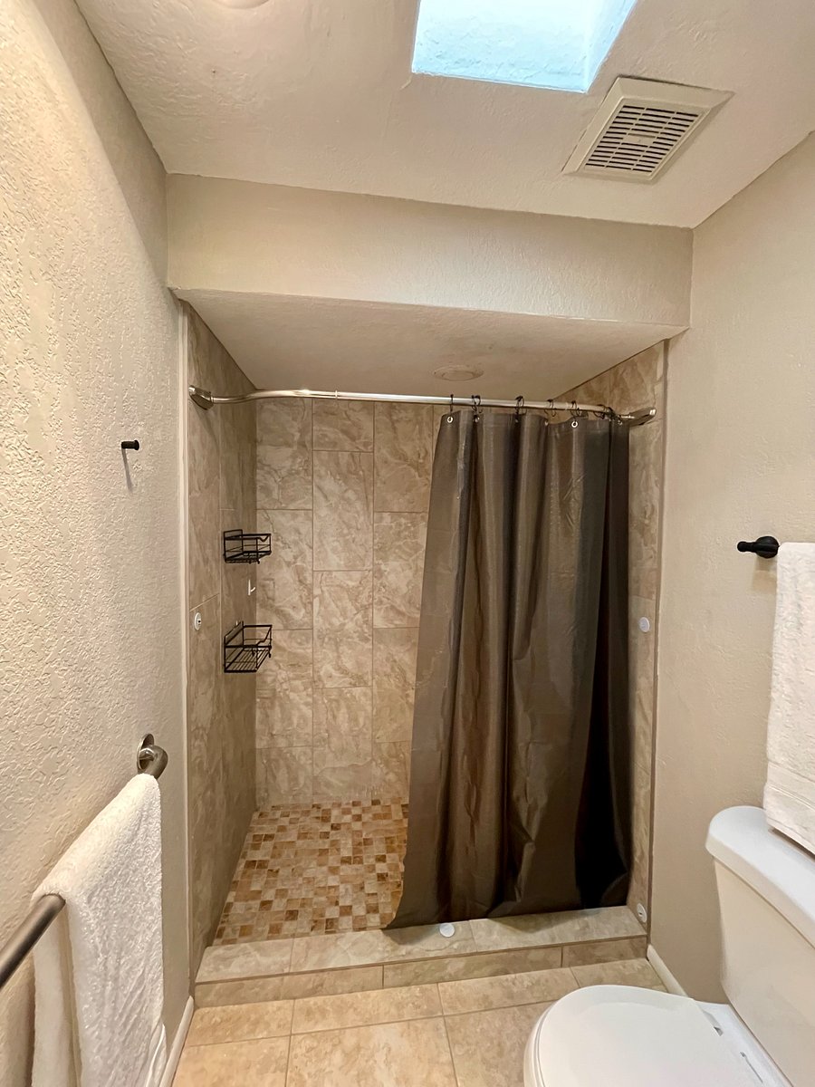 walk in shower and toilet area