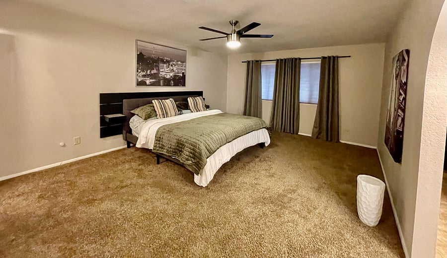 primary bedroom with king bed, fresh linens, blackout curtains
