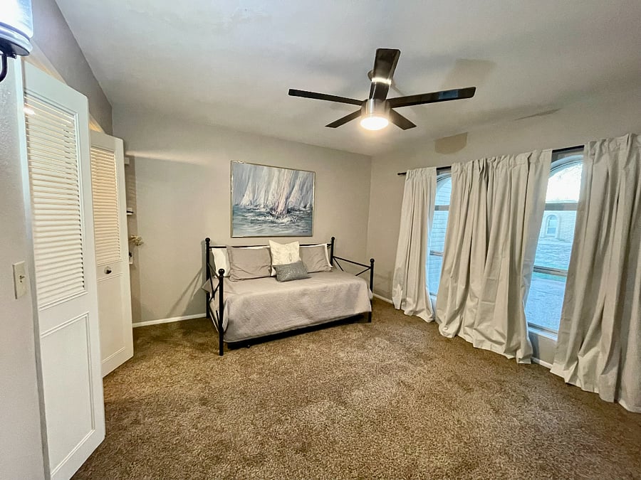 2nd bedroom with black out curtains and double door closet