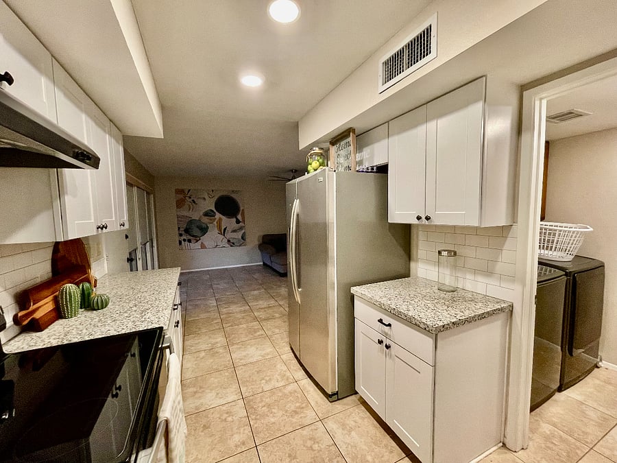 updated kitchen with large laundry room with washer, dryer & additional cabinetry