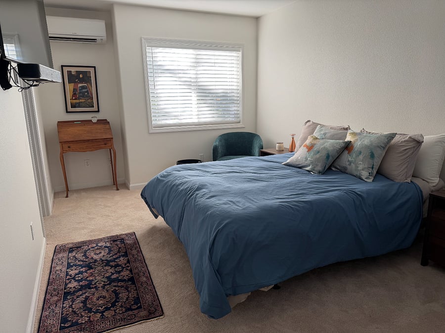 Master bed in bedroom. With TV on left.