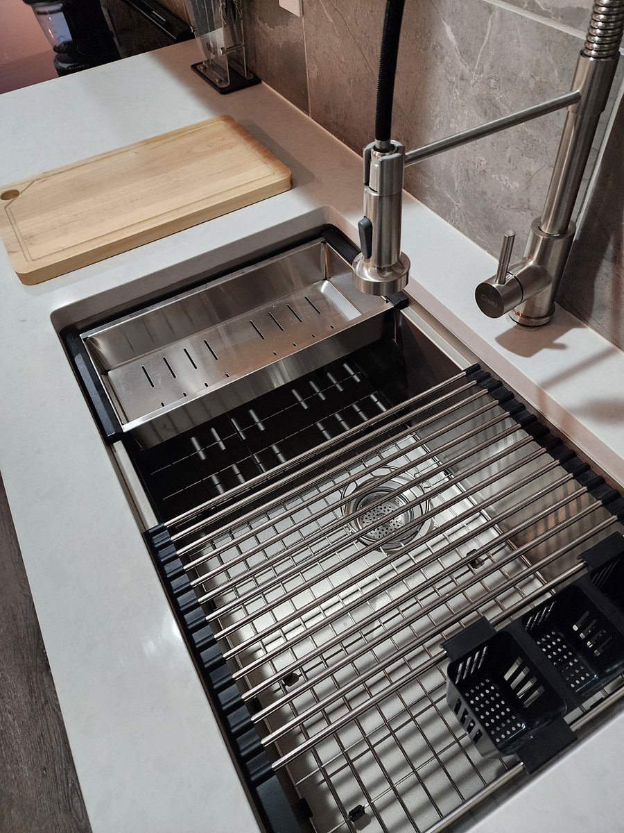 Deep kitchen sink with modular accessories.