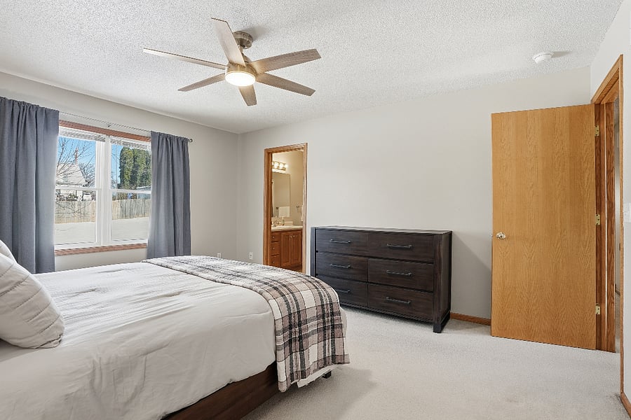 The upstairs boasts three bedrooms, including this large master bedroom with an en suite bathroom with bath and shower.