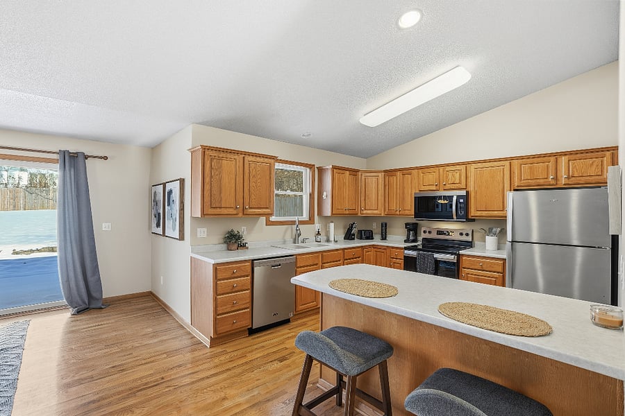 Kitchen opens to the dining room with a view to the big backyard. Brand new appliances have been added, along with everything you will need for a comfortable stay.