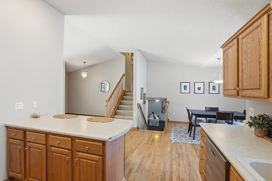 View from the kitchen to the split level for a lower level living space and upstairs to the three roomy bedrooms.