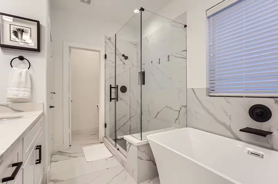 Primary bedroom features large shower and bathtub