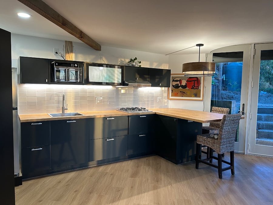 Well equipped kitchen with a large fridge and an abundance of small appliances, microwave, convection, toaster oven, air fryer, powerful blender, cuisinart, coffee maker, and crock pot. Huge pantry to store provisions (not shown).