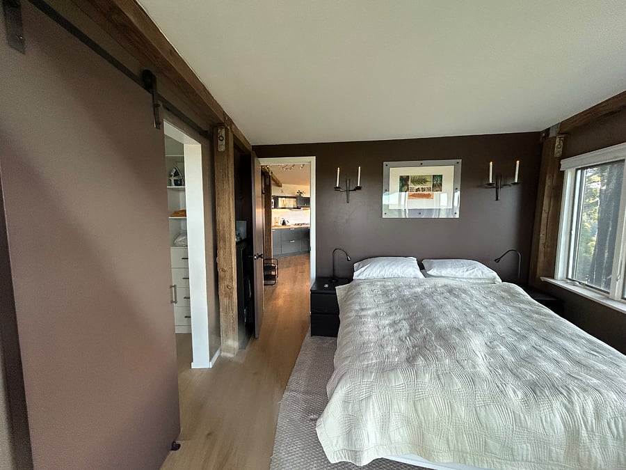 The bedroom is a calm and soothing space with restful colors. A sliding glass door leads to the yard outside and is an alternative way to enter the living space from the parking area. Mood lighting with electric candles/remote and generous drawers in each bedside table.