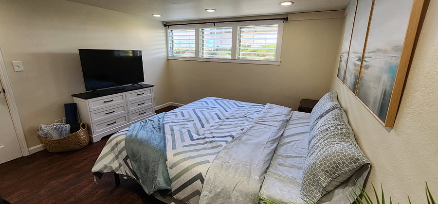 Bedroom with king size memory foam mattress and 50 inch smart TV
