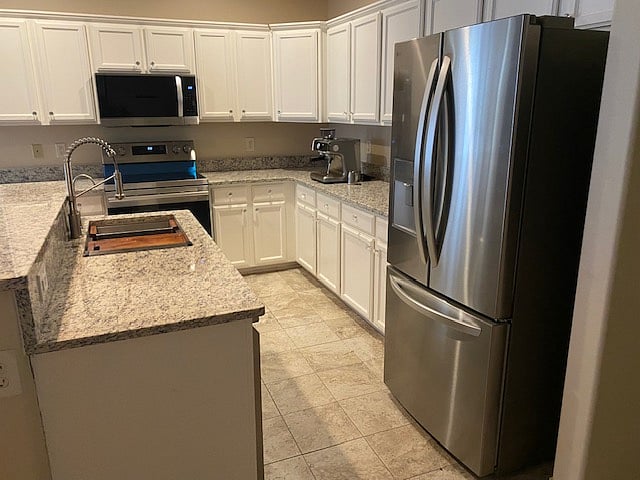 Kitchen with all new appliances and new floor tile.