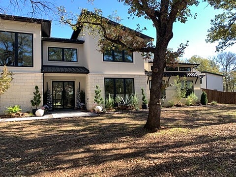 Front of main residence showing apt/casita on right side of backyard behind fence. 
