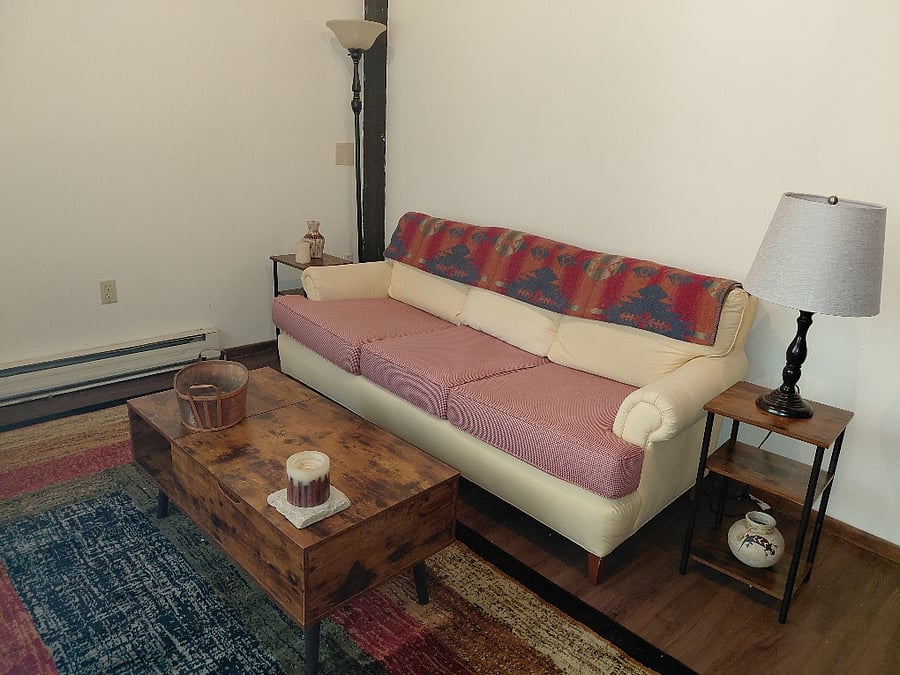 Living room. Newly stuffed and covered couch.