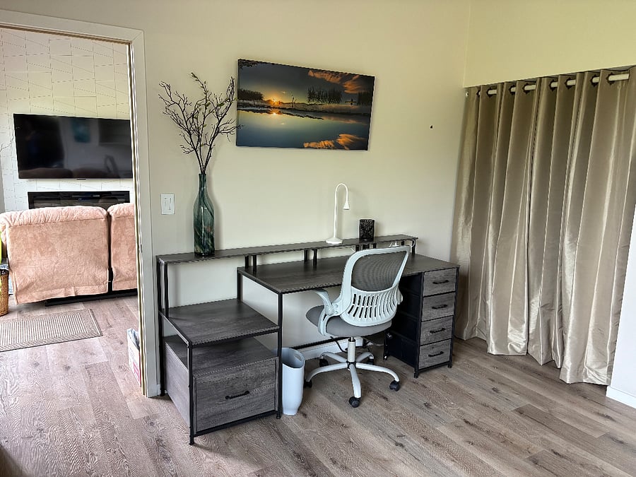 Desk in main bedroom with walk-in closet behind the curtain screen
