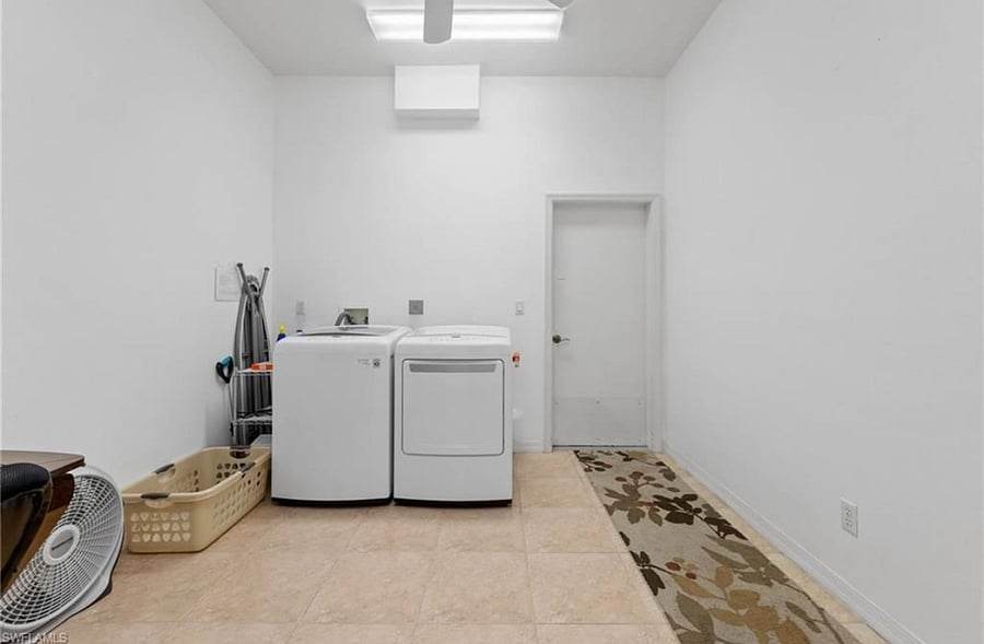 Oversized laundry room with ironing board