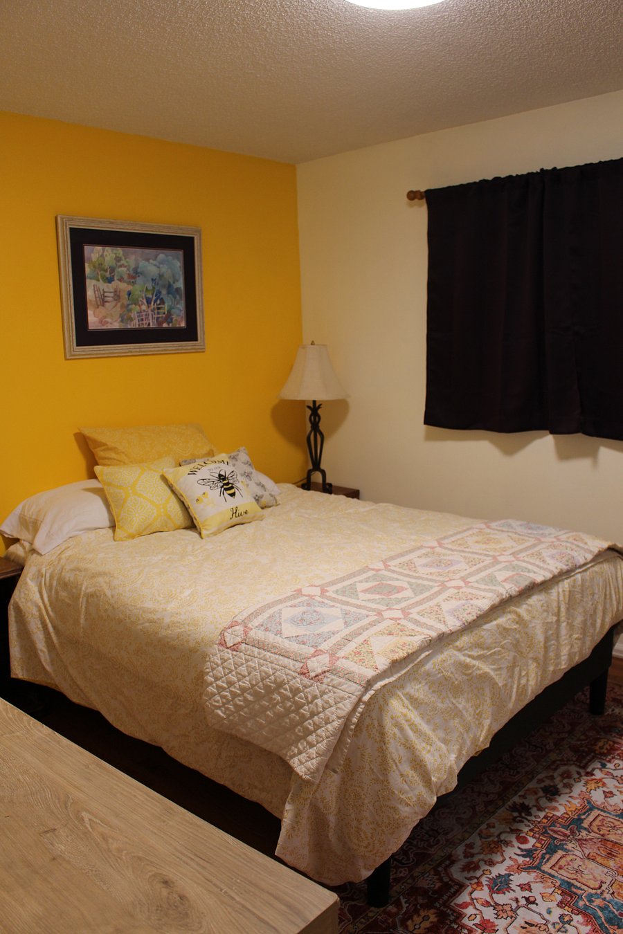 Cheery primay bedroom with queen bed