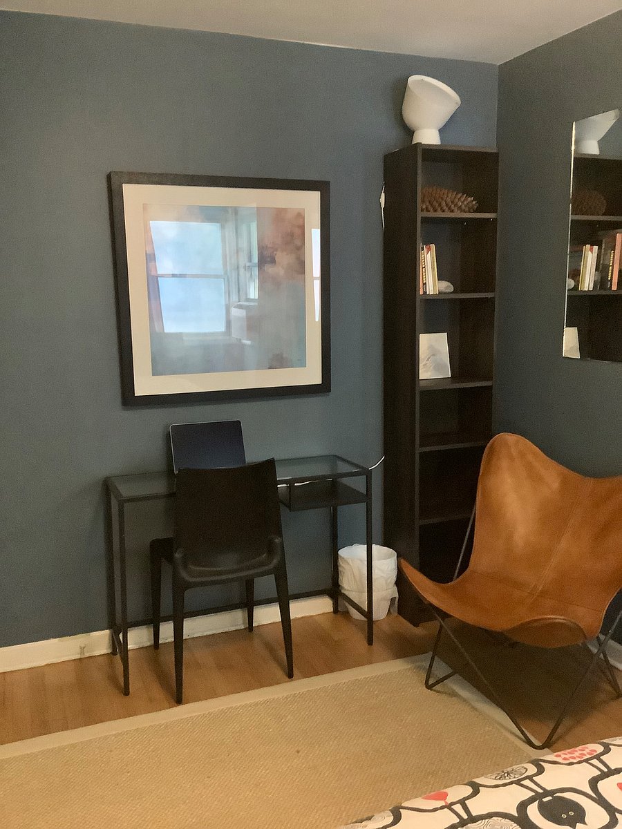 Small desk area with bookshelves. Butterfly chair for reading or staging your backpack for your next outing..