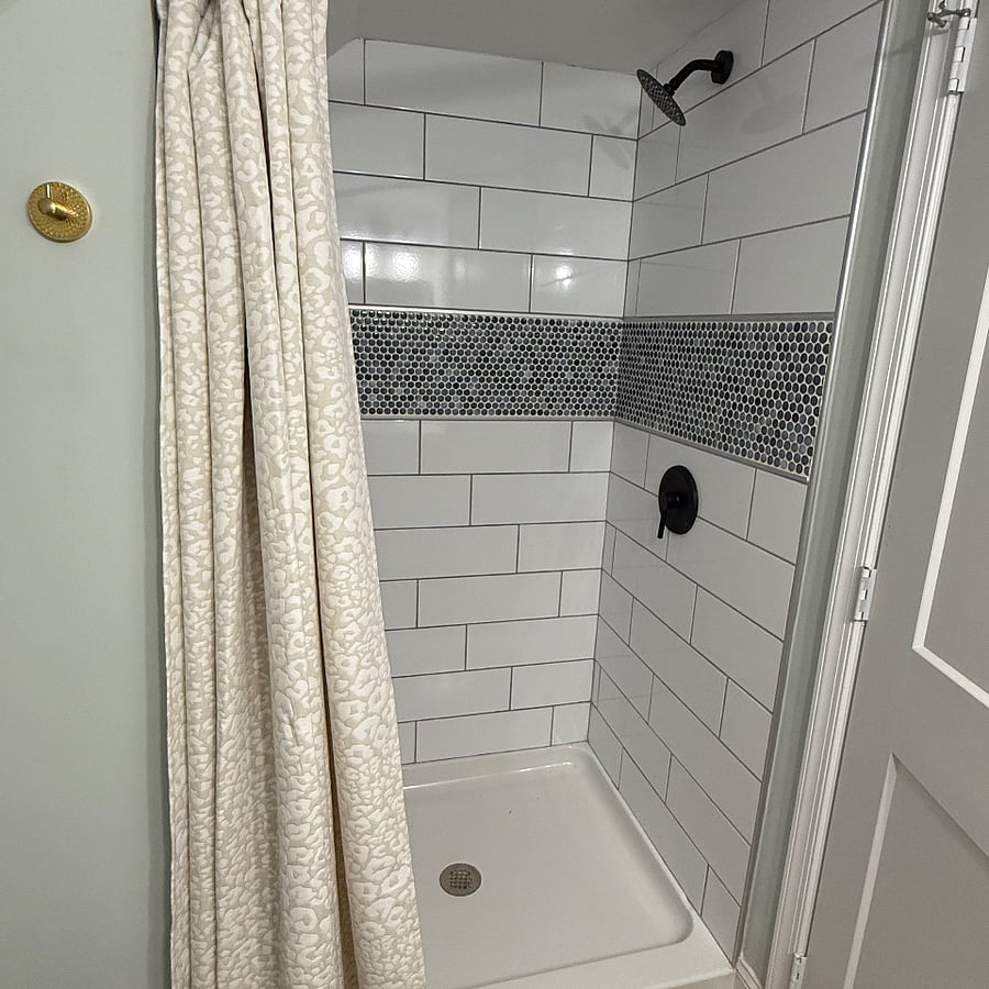 2nd bathroom with shower upstairs.  New tile and shower fixtures.  New shower curtain and liner.  The shower is asymmetrical--unique space. 
