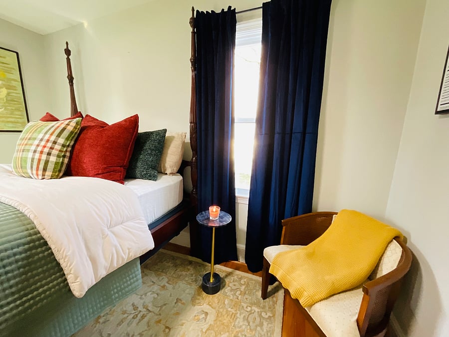 1st bedroom to the left of the house. Located on the 1st floor.  It is a Henkle HarrisCanopy Bed.  New mattresses and box spring.  Blackout curtains. Pillows can be used as needed.  Floor lamp is in this room and a 3 drawer dresser. And a Henkle Harris mirror. Closet space. 