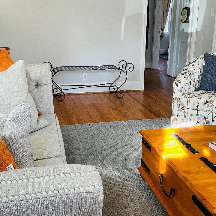 Another angle of the living room as people enter the home. The wrought iron seater can be used for extra seating or place your belongings on there, suitcase, pocketbooks, etc. 