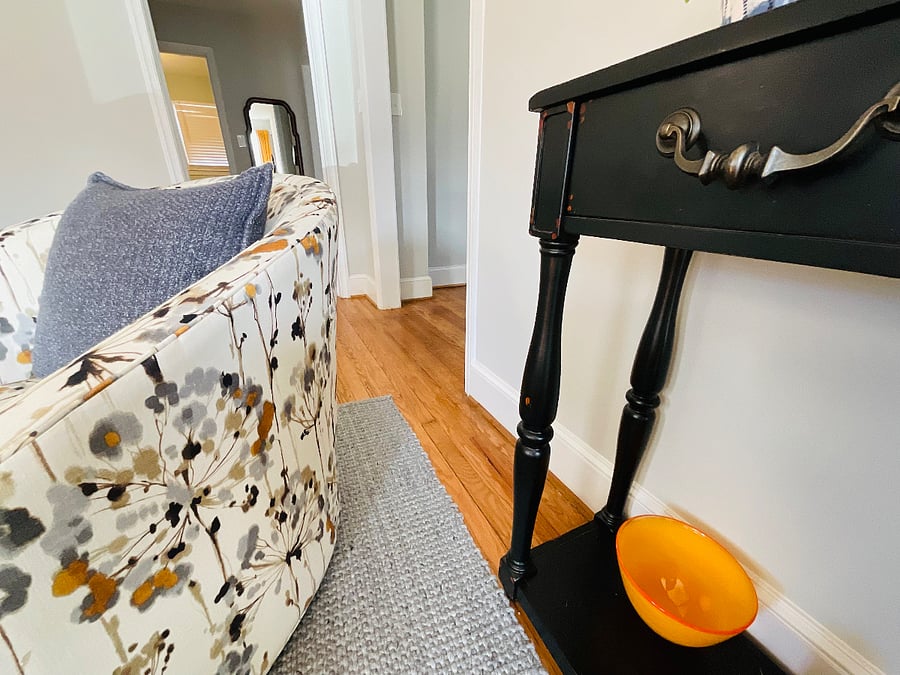 Snap of Console Table in living room.   The smart TV sits on it, in addition to other pillows and nice bowls and plants.  