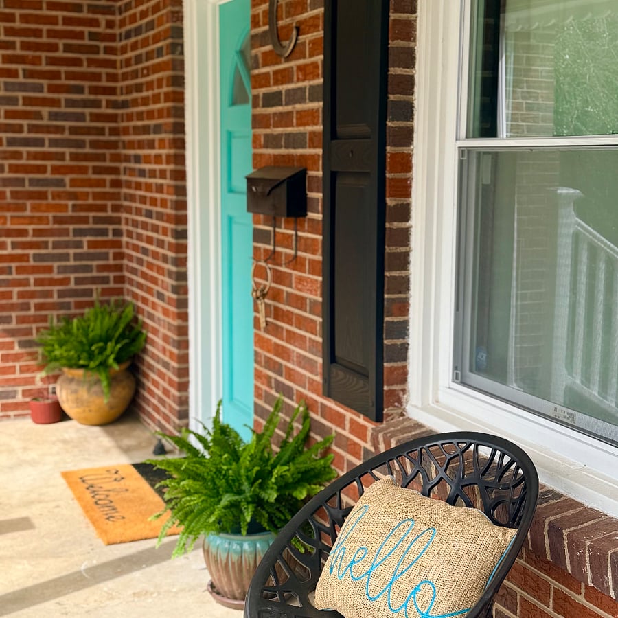 Spacious Front Porch to people watch or to enjoy mornings on the porch.  2 sitting chairs and plants.  