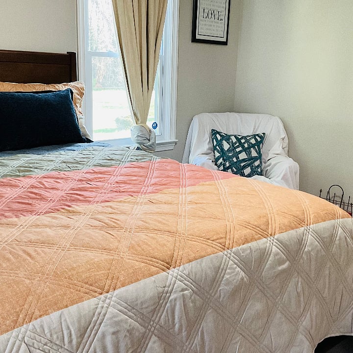 Another angle of the 2nd bedroom.  Fun Chair for siting or reading. it is covered but can be removed. It is red.  Book rack and briefcase in this room and fun art work.     Beautiful view to the backyard. 