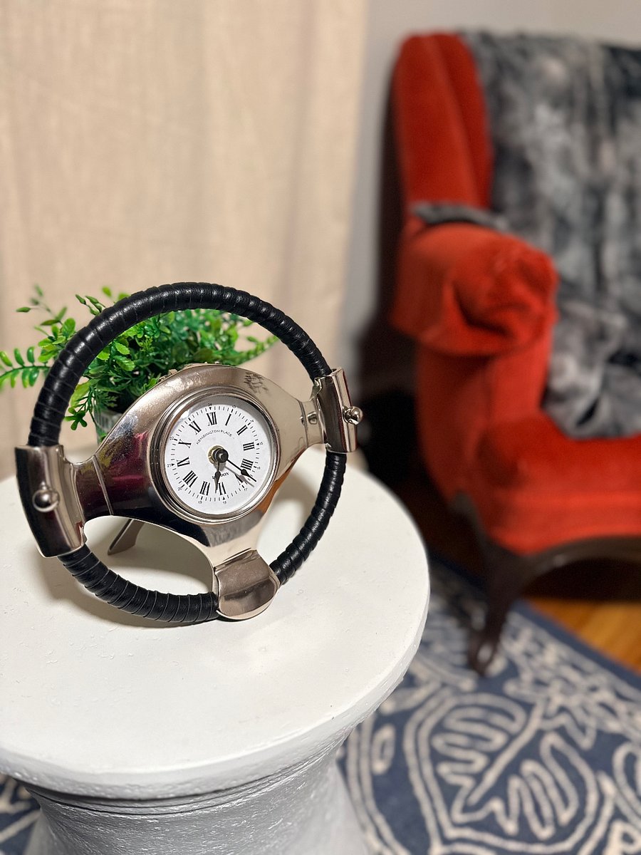 Just a few shots of the 2nd room. This is a steering wheel clock.  Move it or keep it there, and use stand for drink, book, cell phone, etc.  The Wifi router is in this room.  Nice linen curtains that drape down to the floor. Closet space and more linens in case you need it.
