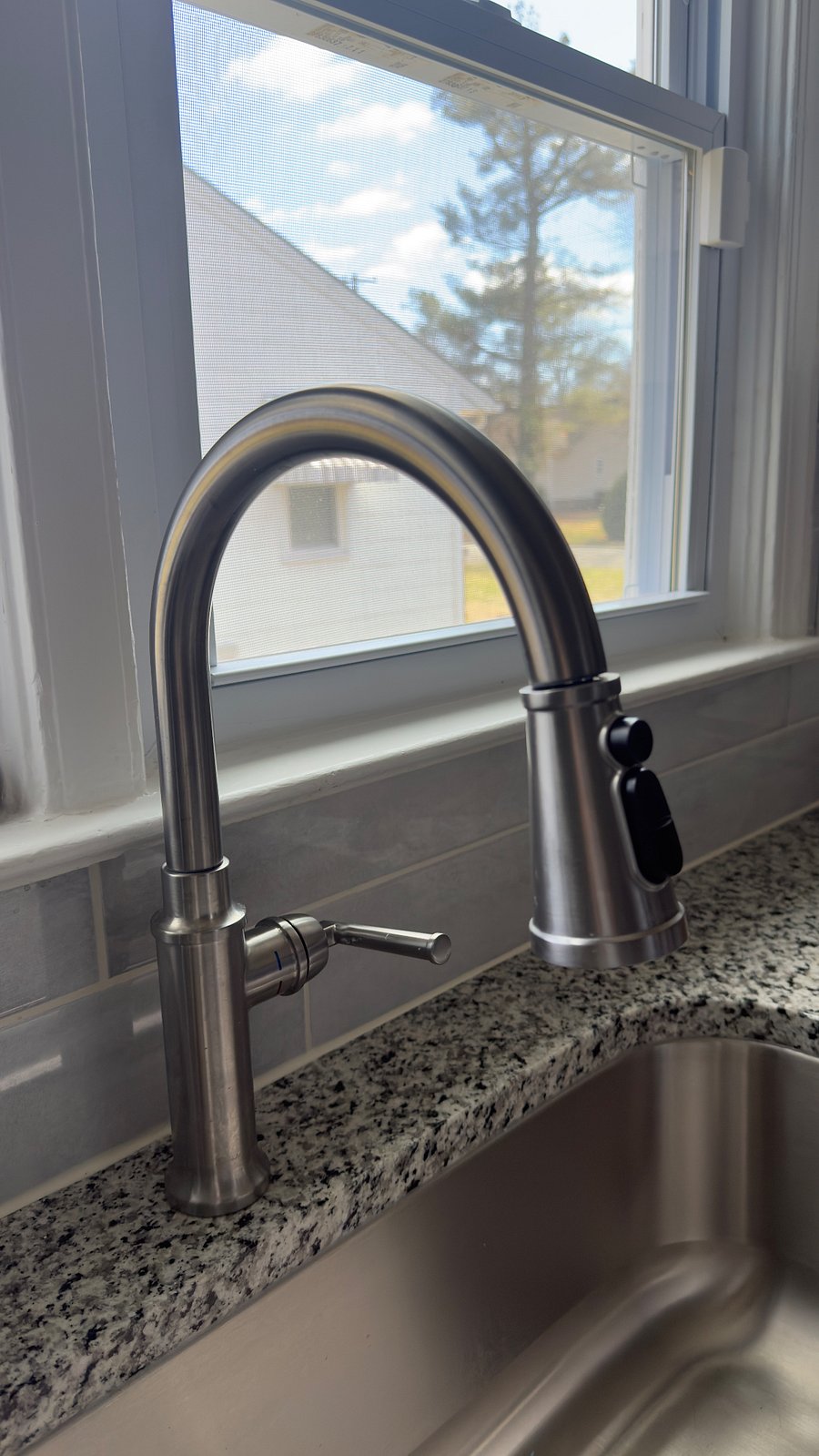 Kitchen sink overlooking outside on the first floor. Granite countertops.  