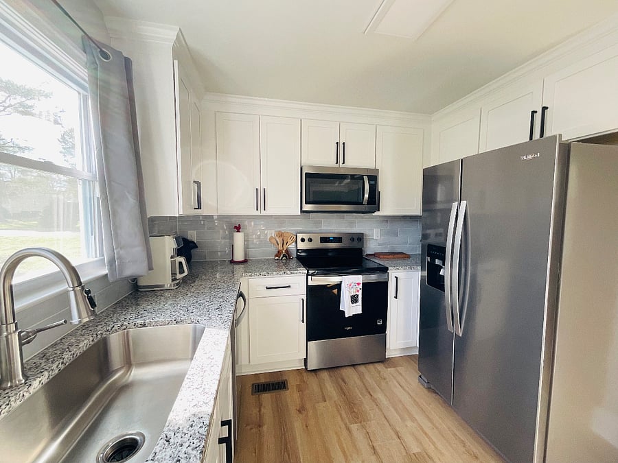 Kitchen on first floor. Stainless Steel applicances: dishwasher, garbage disposal,microwave, refrigerator. Crown molding throughout. A LOT of cabinet space.   Recess lighting underneath each cabinet. 