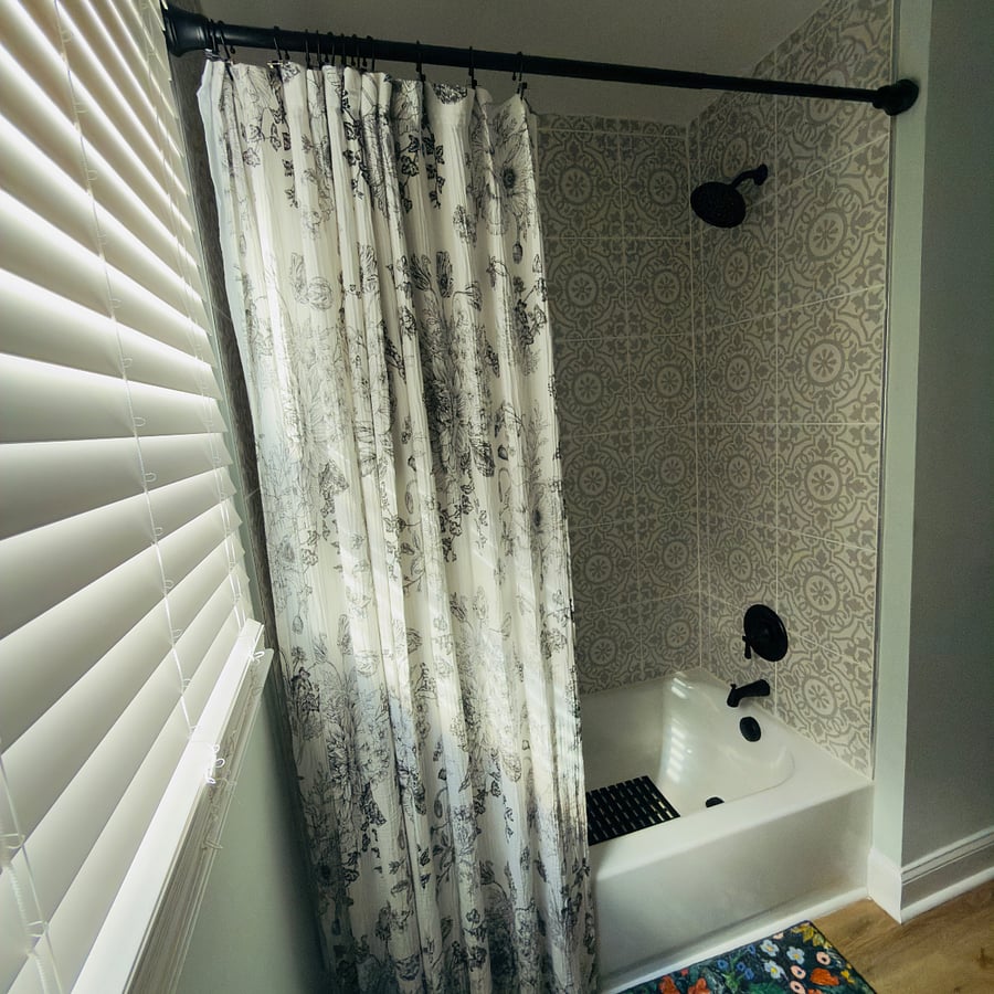 Another view of the full bathroom downstairs. Wood blinds.  New shower curtains and liner.  Towel brass hooks throughout the bathroom.  Non slip bathroom rug. Extra towels in built in closet in the bathroom. 