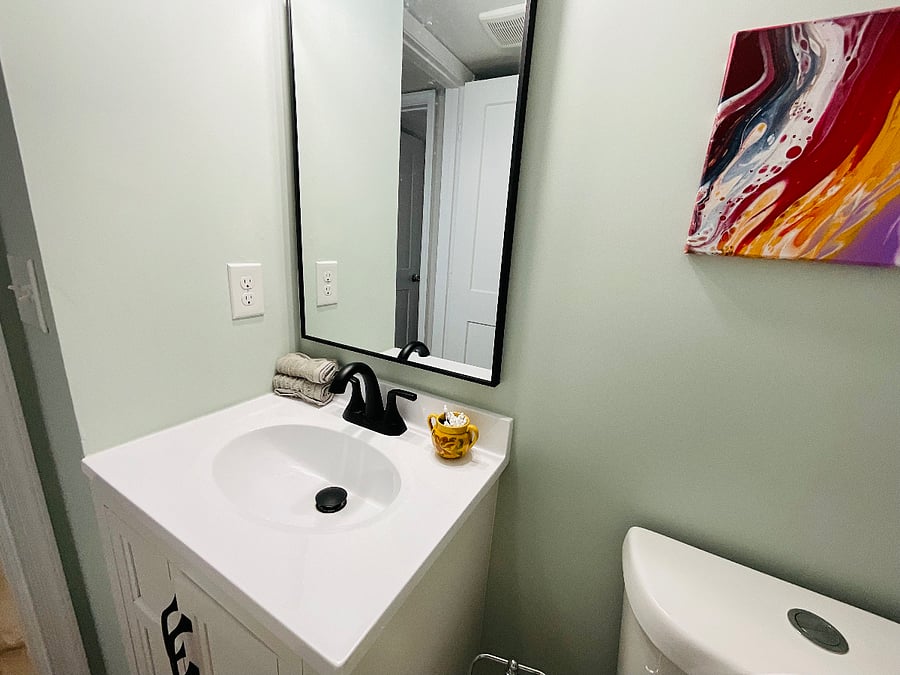 Full bathroom with shower upstairs. Cabinet filled with tissue and wash cloths. A little art work.  New toilet. Bathroom is adjacent to the sitting area in the hallway.  Unique space. 