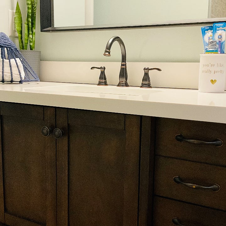 Bathroom cabinet with new fixture and tile on the first floor. First aid kit, extra toothpaste and mouthwash in case you forget yours.  Extra towels in the built in cabinet. 